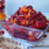 A beautiful serving dish of Easy MOstly Bakes Signature Cranberry Relish boasts slices of mandarin oranges, black currants, nuts, celery and cranberries.