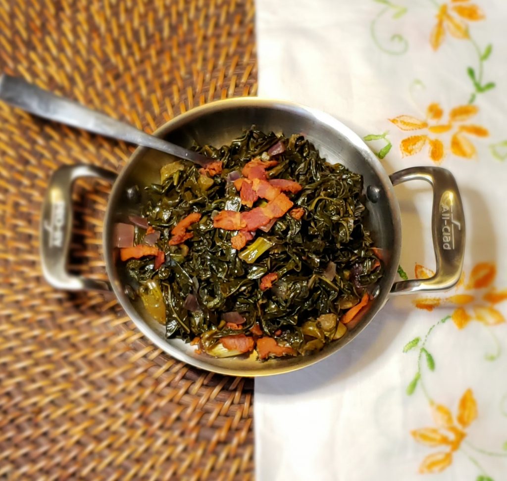 A bowl of Easy 5-Ingredient Sweet and Sour Greens is topped with crunchy bits of bacon.