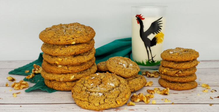 A tall stack of 5-Star Brown Butter Peanut Butter Cookies sits next to a tall glass of cold milk.