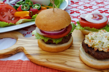 A burger bun is generously covered with the Best 3-Ingredient Olive Sauce in Michigan.