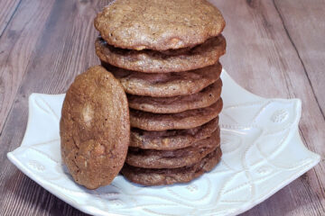 A tall stack of Easy 4 Chocolates Lime Cookies stands ready on a simple white plate.