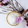 Easy 4-Ingredient Lychee Coconut Sorbet. A frosty bowl of lychee coconut sorbet sits nestled among lychee twigs, peeled lychee fruit, lime slices and fresh flowers.