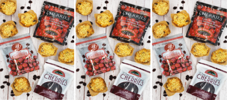 Fresh baked Authentic Montmorency cherry lime streusel muffins, dried Montmorency tart cherries and bags of dried cherries stretch across a distressed, whitewashed board.