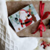 Festive wrapped presents and toys sit upon a plush white fur rug - items found at a local store by implementing Maria's 2 Ways to Slay Your Holiday Gift List Early.