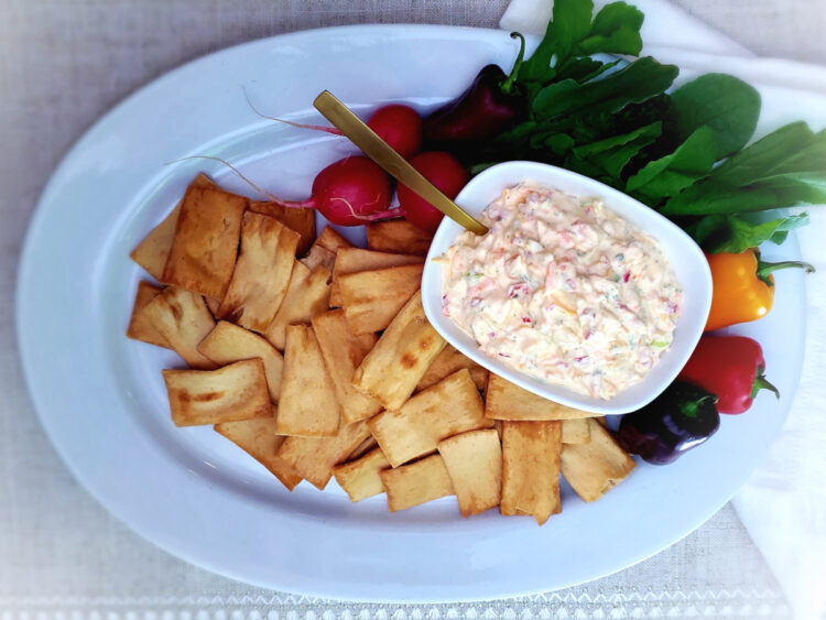 A beautiful platter of fresh vegetables and pita chips is complimented by a serving bowl filled with this Fresh and Easy as 1-2-3 Garden Veggie Bar Cheese