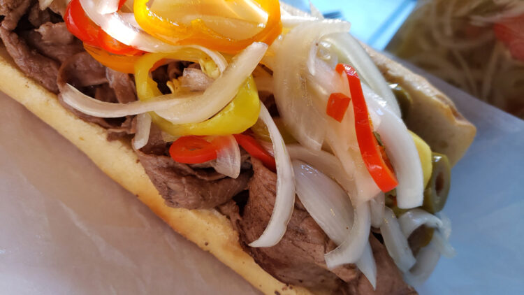 A shaved steak sandwich on a french roll is generously topped with this Simple Sweet and Spicy 15-Minute Giardiniera