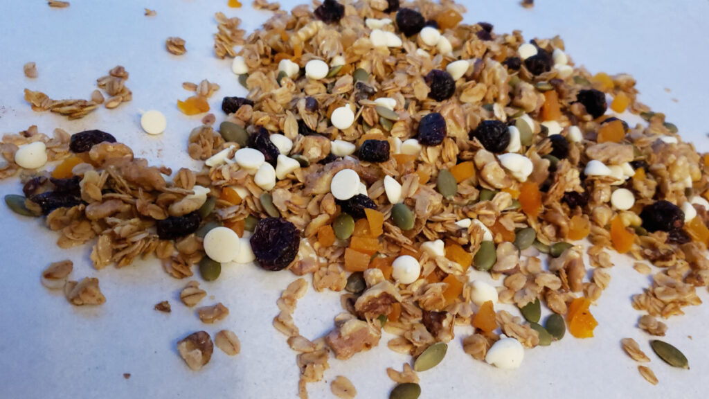 A batch of Crazy Simple 15 Minute Skillet Granola is packed with clusters of dried fruit, toasted oats and nuts, with a hint of cinnamon spice and just the right amount of sweetness from maple syrup. White chocolate chips were added for fun to this tasty, on-the-go snack. 