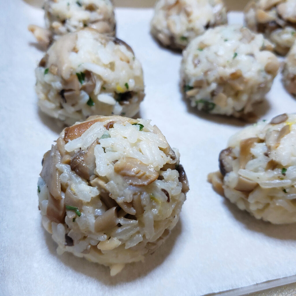 These Easy Mushroom Arancini in 2 Hours are stuffed, rolled and ready for the next stage of preparation - coating in egg and breadcrumbs and frying.