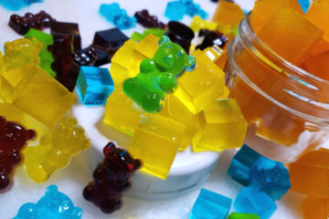 A rainbow assortment of Super Simple Homemade 4-Ingredient Gummy Candy is pictured. Yellow lemon, Orange flavored orange gummy squares, dark red blueberry pomegranate, blue licorice flavored and green lime.