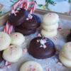 A tray of these Easy 4-Ingredient Minze Patties. Some of the peppermint patty candies are dipped in dark chocolate, others in white chocolate. Candy cane sprinkles decorate the tops.