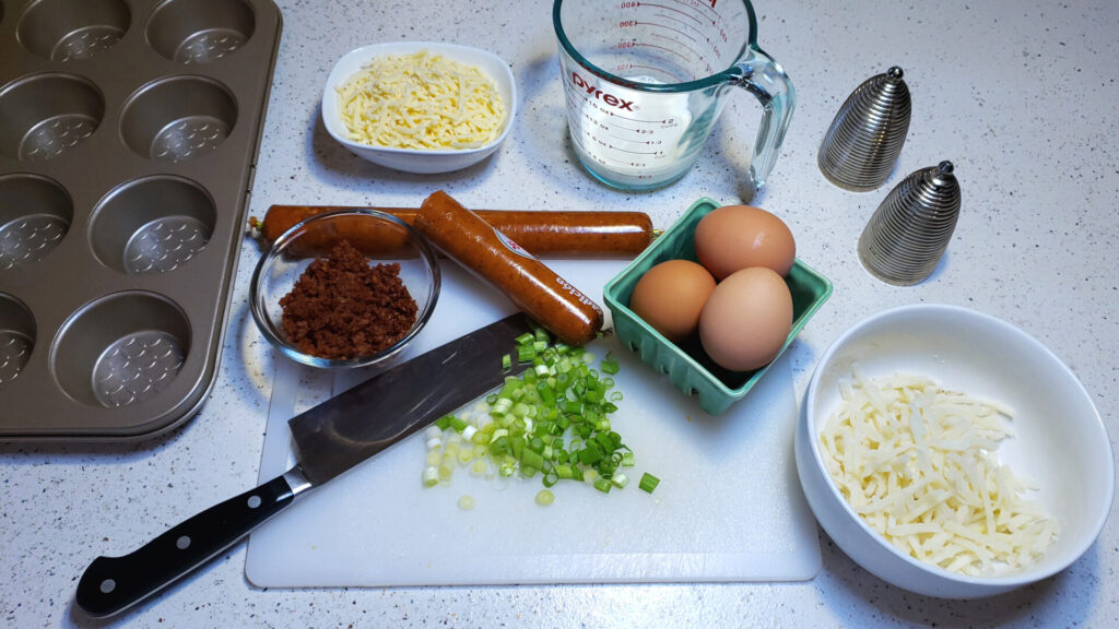 Ingredients for this Easy Mexican Style Mini Quiche in 30 Minutes recipe line a cutting board.