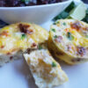 A tray of hot out of the oven Easy Mexican Style Mini Quiche in 30 Minutes. Each quiche has pieces of jalapeno, onion, chorizo and potato suspended in a light, fluffy egg mixture.