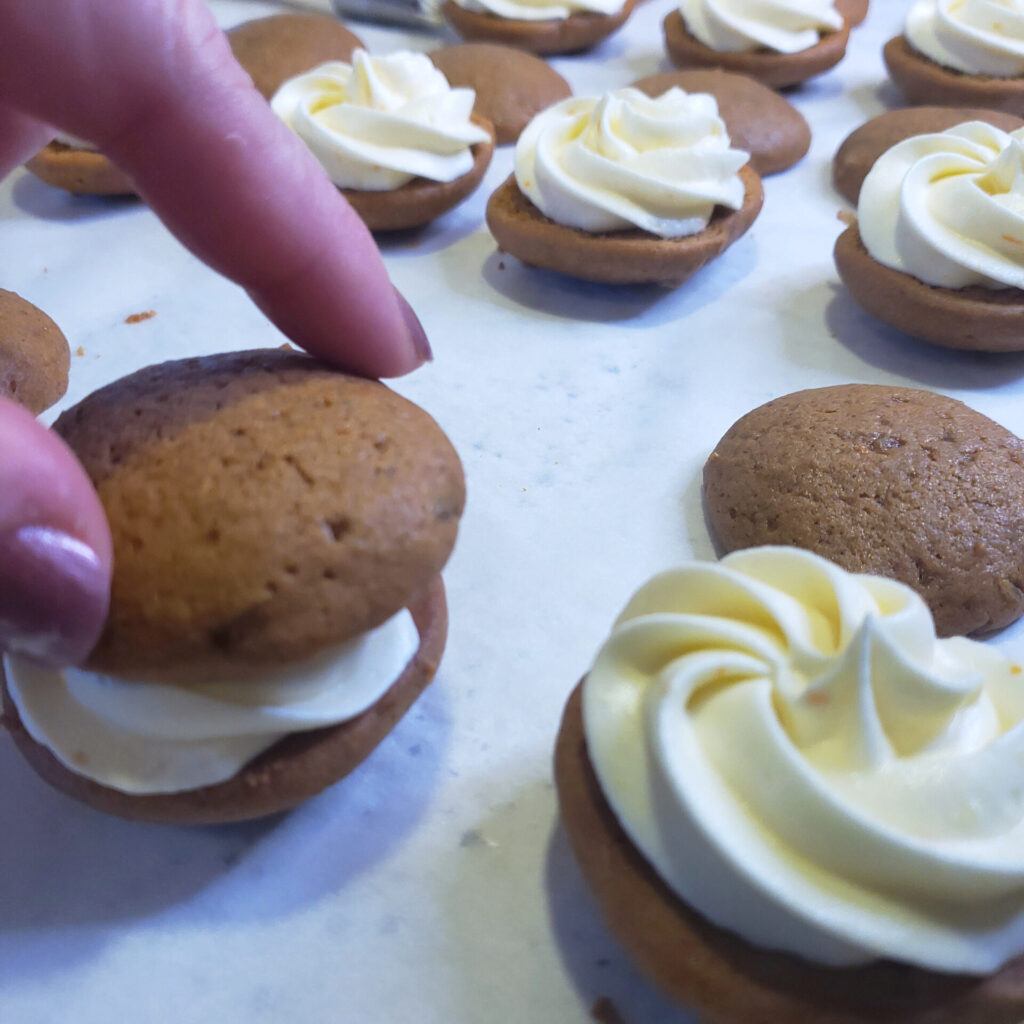 Filling is piped between two cake-like cookie layers in these Easy as 1-2-3 Triple Ginger Whoopie Pies.