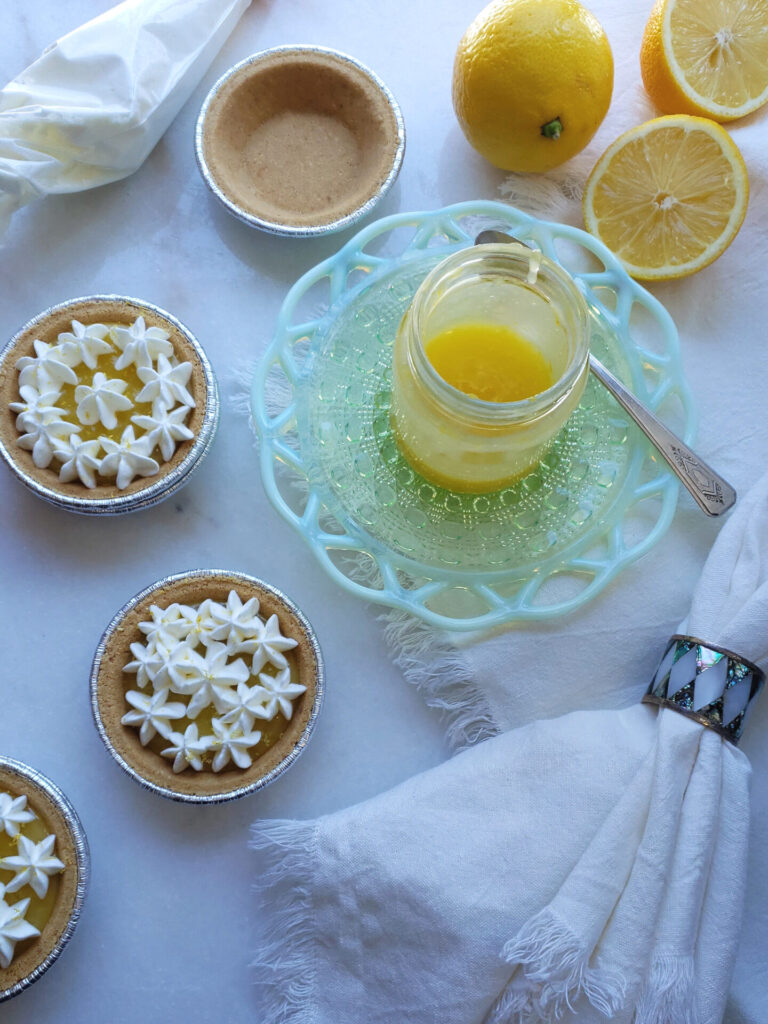 Simple lemon tarts are filled with this Quick and Easy 4-Ingredient Lemon Curd and topped with whipped cream.