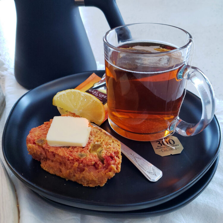 A slice of this Vibrant 1 Hour Turmeric and Golden Raisin Irish Soda Bread reveals a surprising color change brought on by an interaction between the turmeric and other ingredients.