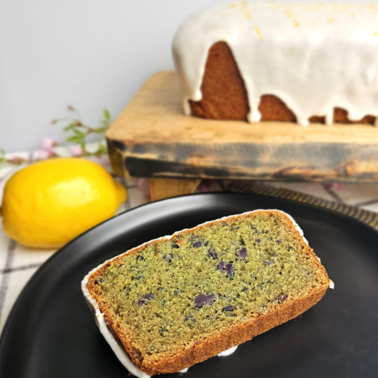 A slice of this Tempting 2-Step Purple Sweet Potato Quick Bread reveals flecks of sweet potato throughout the bake.
