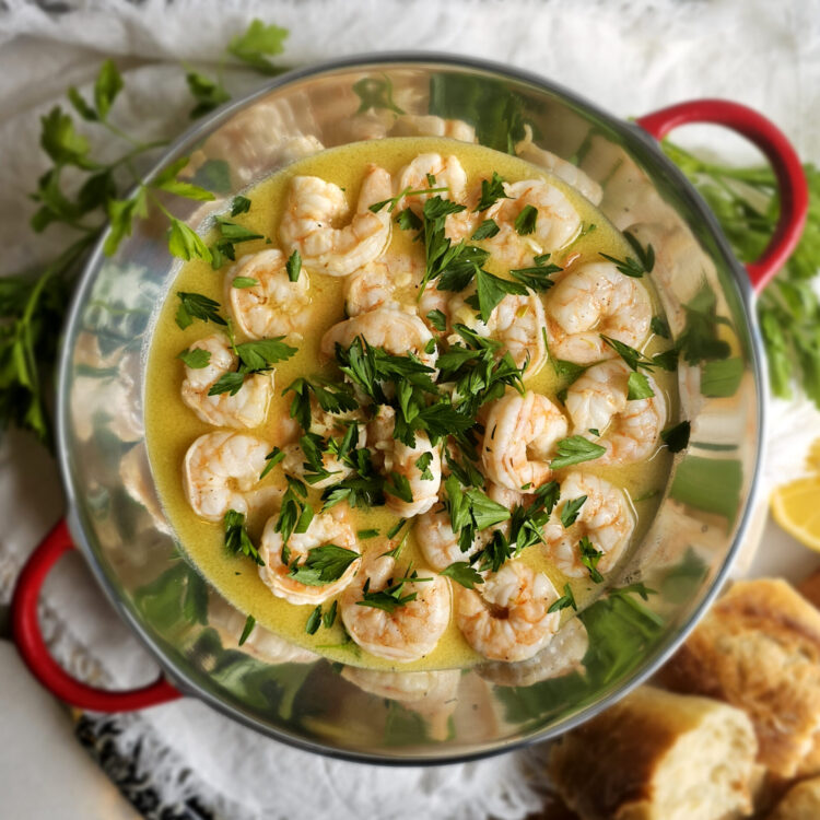 A finished serving dish of this Ridiculously Easy Shrimp Scampi in 20 Minutes sits at the center of a table waiting to be served.