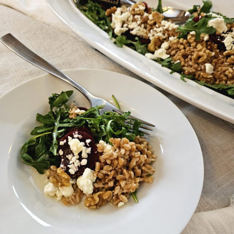 Farro, feta, toasted walnuts and pickled beets over a bed of Arugula are lightly dressed in honey shallot dressing in this Easy Pickled Beets Salad.