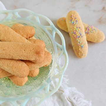 A plate is stacked high with these Best Homemade Italian Lady Fingers in 1 Hour.