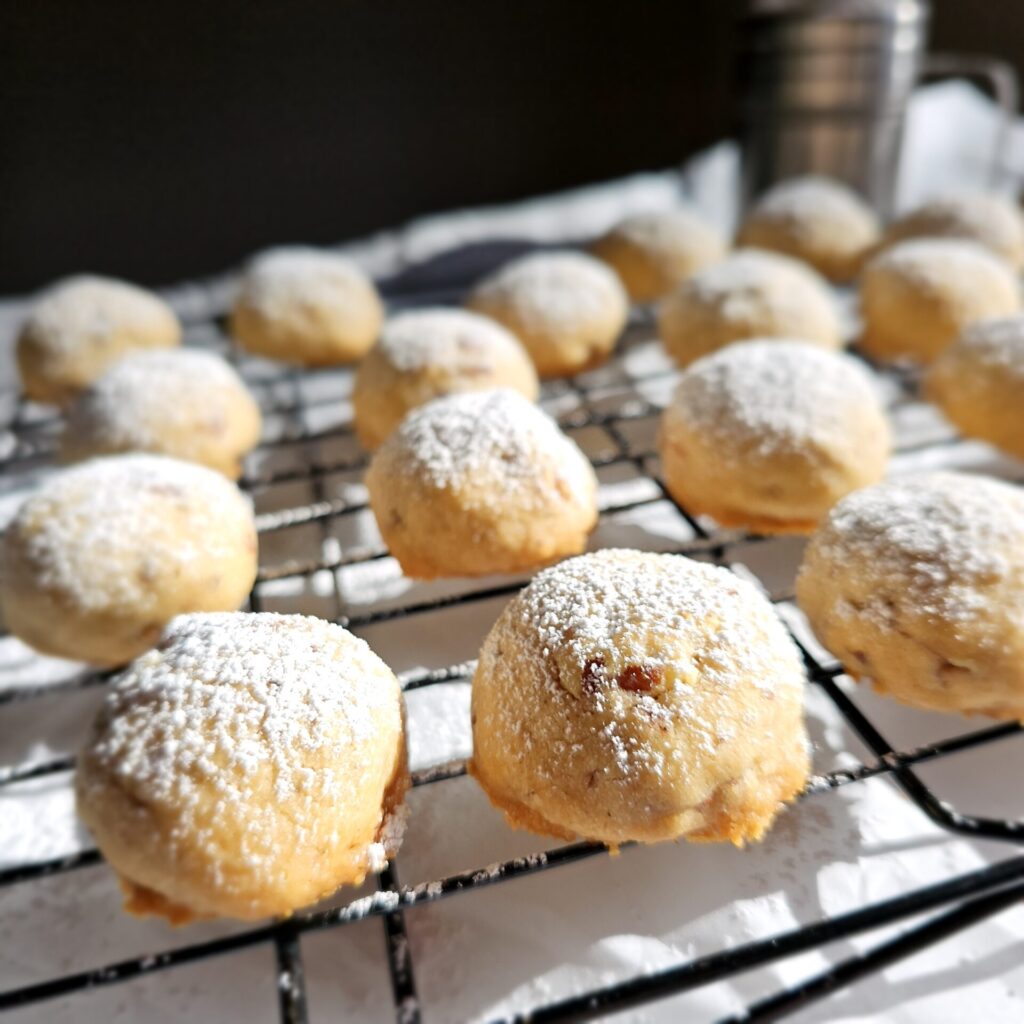 A tray of these Easy Old Fashioned 2-Bite Pecan Sandies cool on a baking rack in the sunshine.