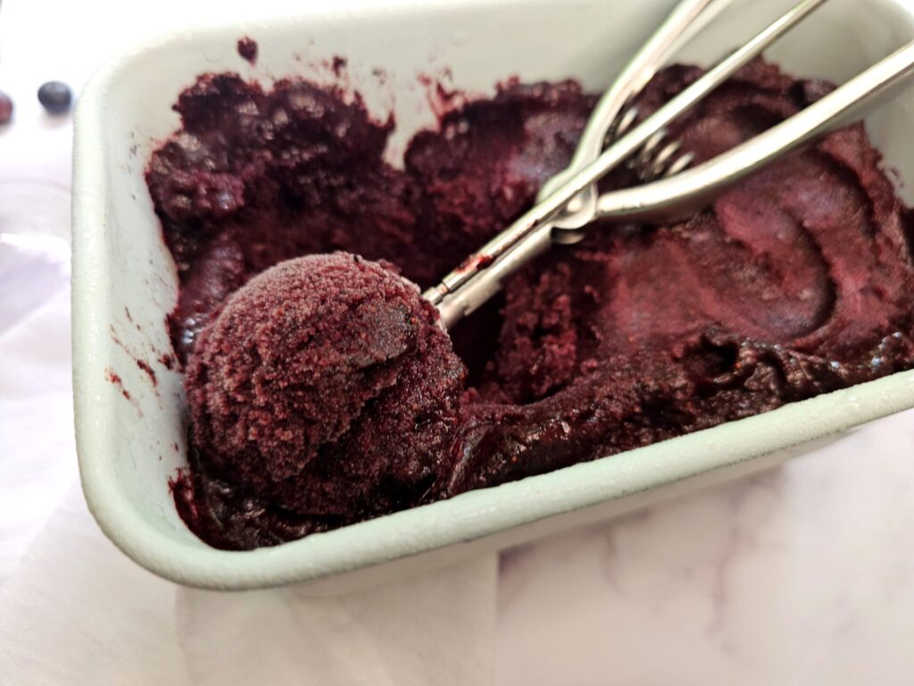 A fresh churned batch of Heavenly Lavender French 75 Blueberry Sorbet is ready to scoop and serve. 
