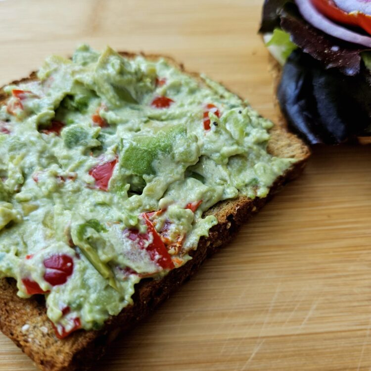 a piece of toast with avocado sandwich spread on it