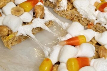 marshmallows, candy corn and peanuts top these fall peanut butter rice krispie bars.
