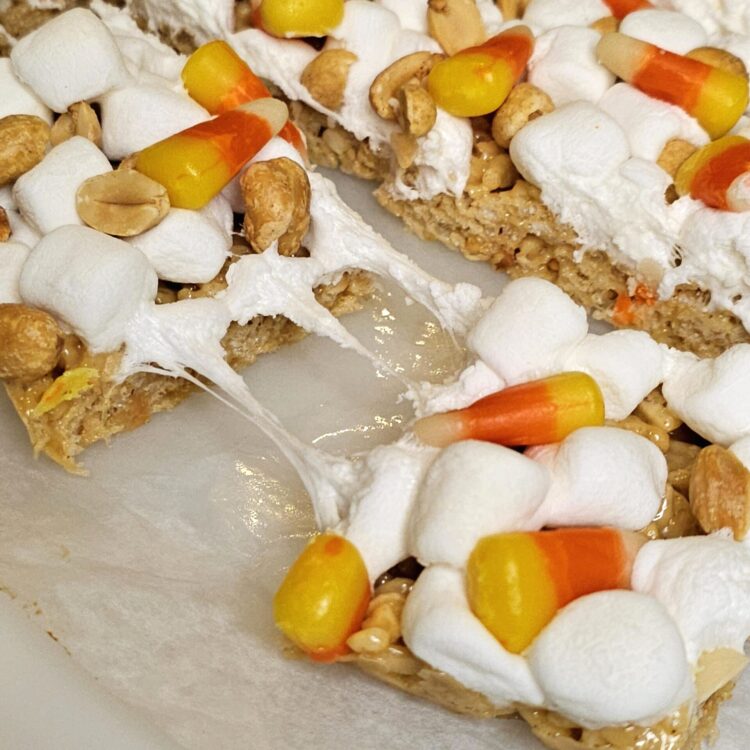 marshmallows, candy corn and peanuts top these fall peanut butter rice krispie bars.