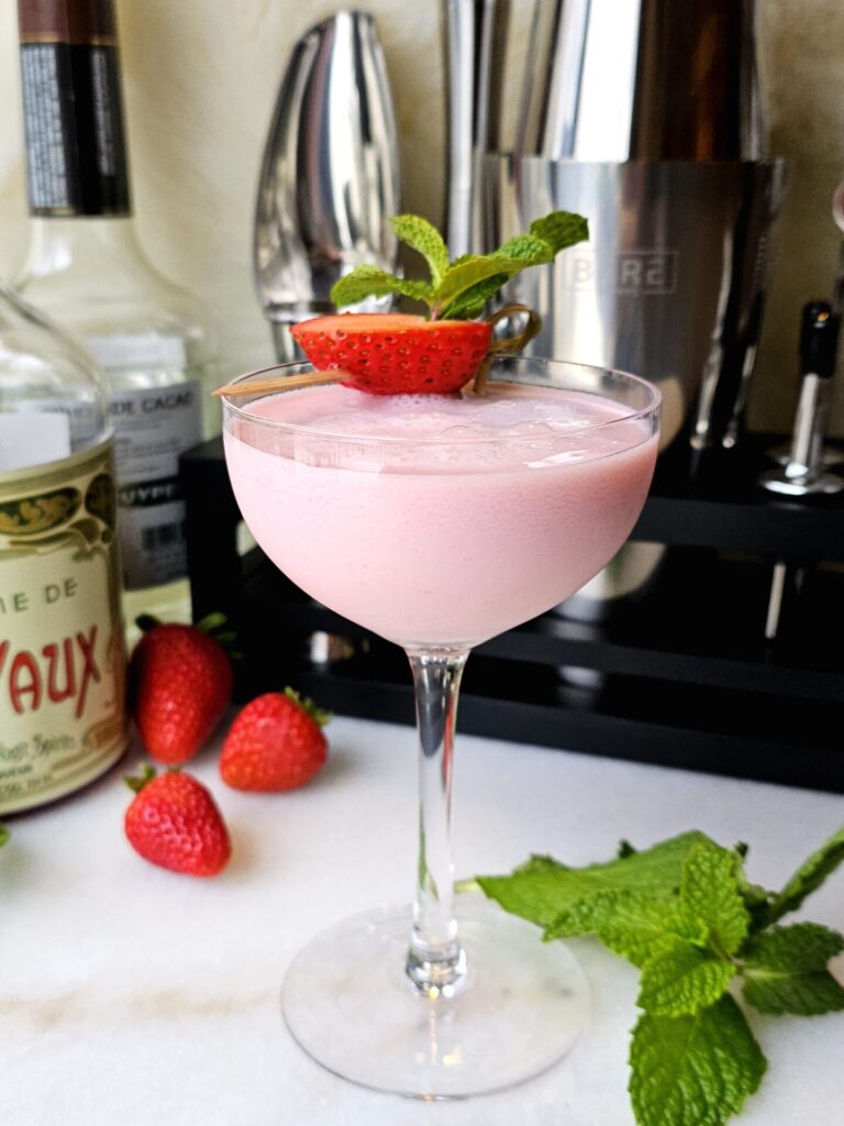 Charming 5 Ingredient Pink Squirrel Cocktail with a strawberry garnish.