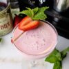 Charming 5 Ingredient Pink Squirrel Cocktail with a strawberry garnish.