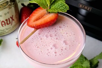 Charming 5 Ingredient Pink Squirrel Cocktail with a strawberry garnish.