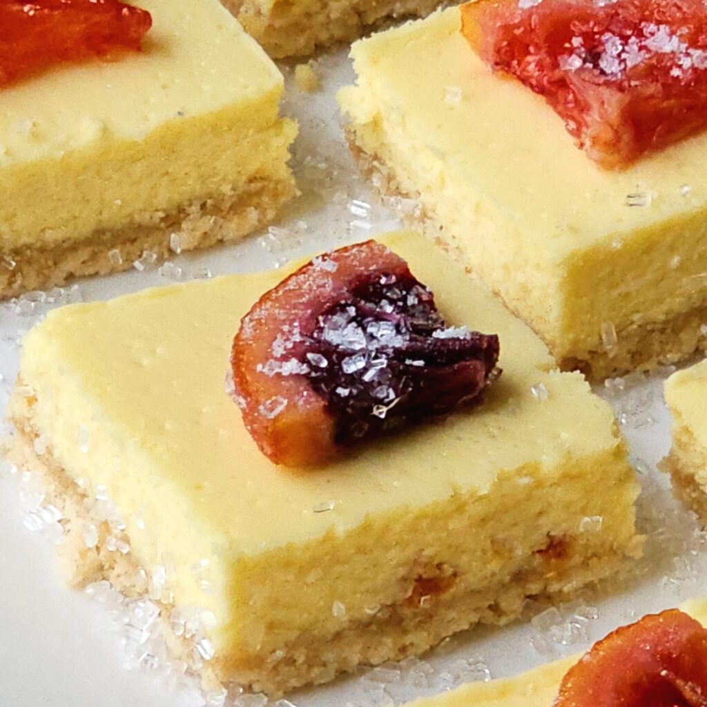 Candied Blood Orange Cheesecake Squares on a serving tray.