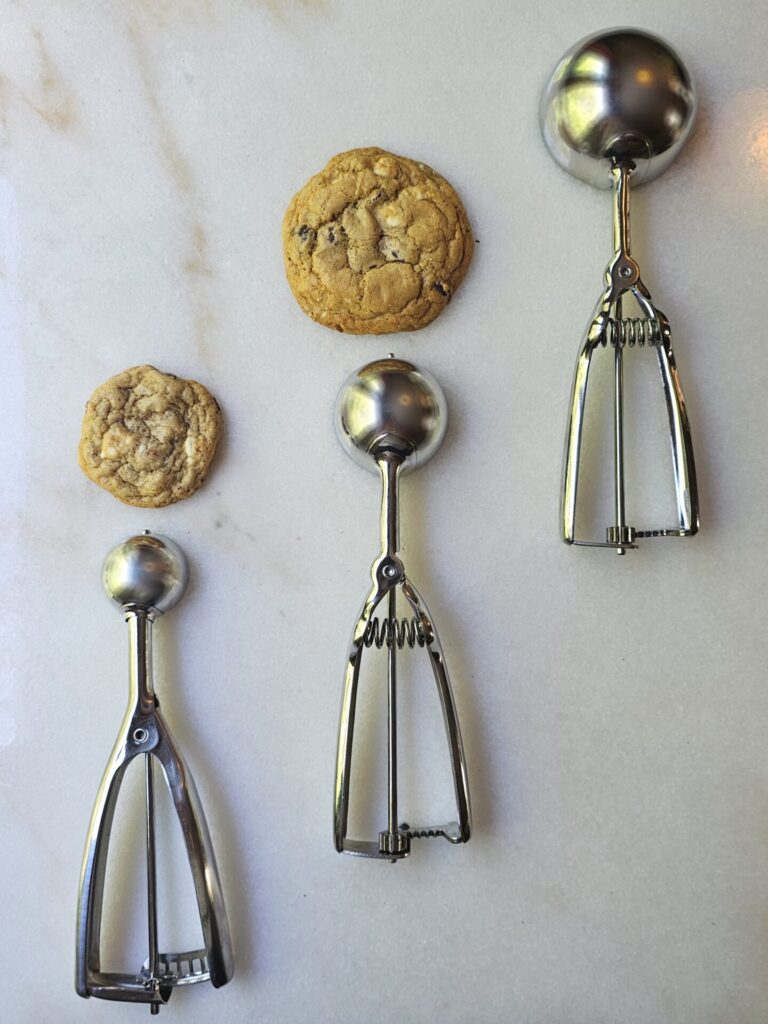 Three scoops are pictured to demonstrate sizes for these Easy Brown Butter Chocolate Chip Cookies.