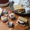 A tray of perfectly toasted Citrus and Cracked Pepper Marshmallows are ready to make s'mores.