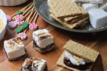 A tray of perfectly toasted Citrus and Cracked Pepper Marshmallows are ready to make s'mores.