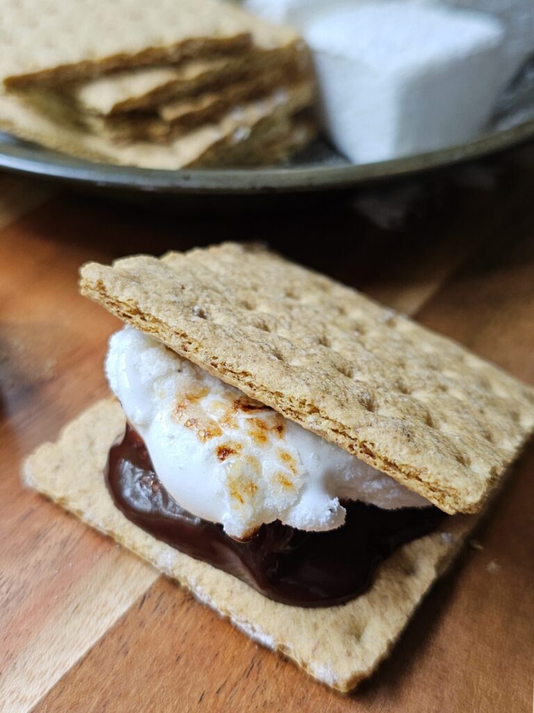 Citrus and cracked pepper marshmallows are toasted and featured in a s'more.