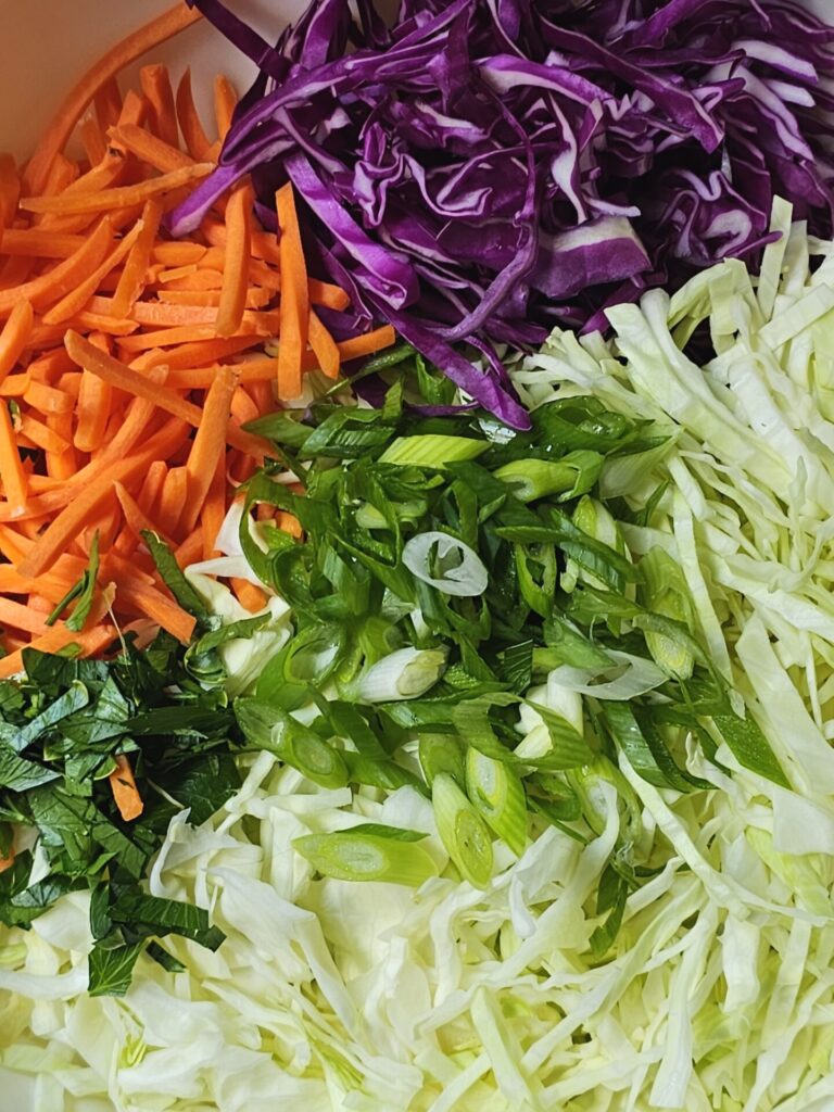 Fresh vegetables are prepared for this Easy Cider Vinegar Coleslaw in 1 Hour