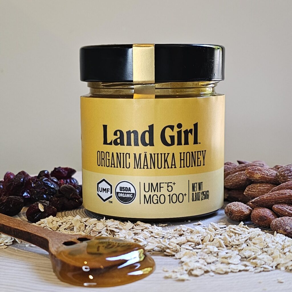 A jar of Land Girl Organics Manuka honey is featured in this image that accompanies the recipe for Easy 5 Ingredient Manuka Energy Balls.