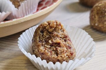 A bite is taken out of one of the Easy 5 Ingredient Manuka Energy Balls pictured.