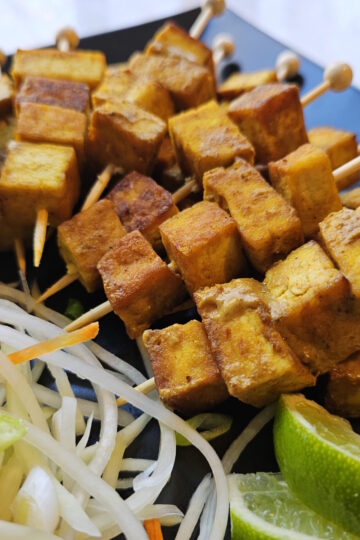 A plate of these Easy Coconut Curry Tofu 2 Ways sits ready to eat.